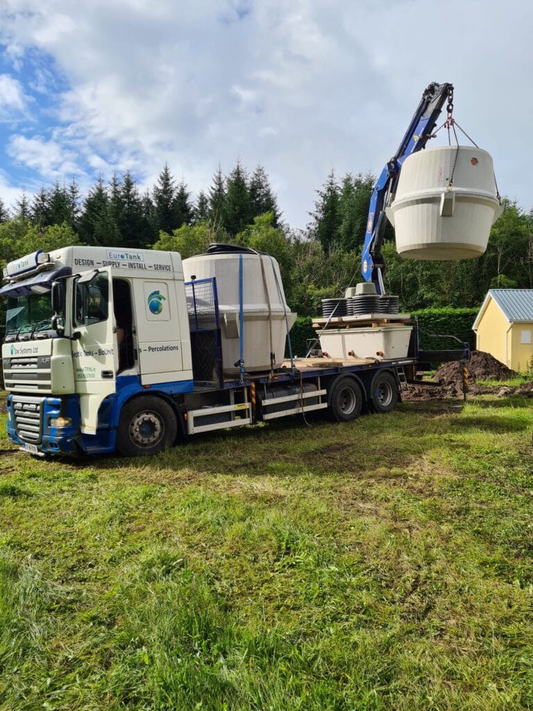 septic tank being loaded off lorry